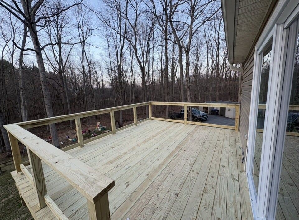 Finished elevated wood deck surface with railing framing